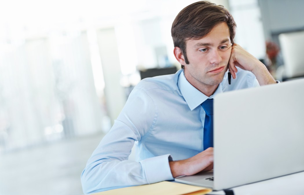 bored business guy at laptop