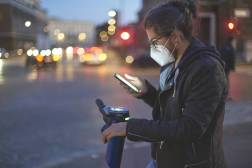 man using smartphone and scooter