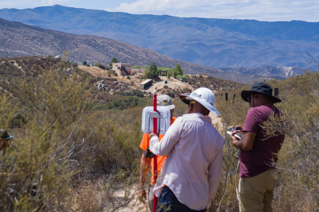 two people configure radio equipment