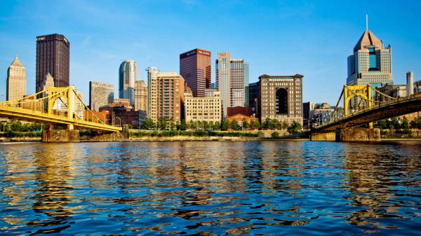 A wide angle view of the Pittsburgh skyline from the North Shore of the Allegheny River. Between the Sixth and Seventh Street Bridges, two of the 'Three Sister' bridges, the view includes many of Pittsburgh landmark buildings.