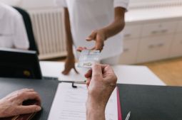 person handing another person a card