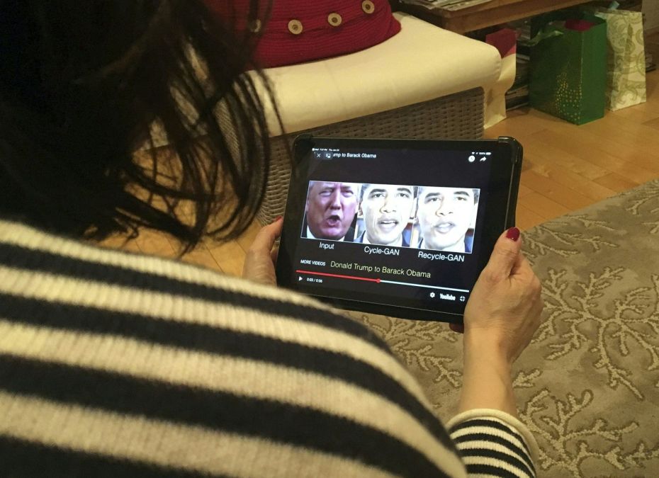 woman holding tablet with deepfake materials