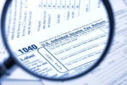 magnifying glass over tax form