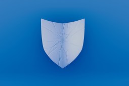 A visually striking blue background showcasing a shield with crack patterns, reflecting concepts of security, protection, and vulnerability in an artistic expression.